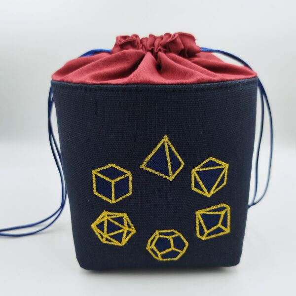 Panière à dés carré noire et rouge brodée avec un set de dés de jeu de rôle (d20, d12, d10, d8, d6, d4) en bleu fermée
