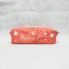 Trousse orange personnalisée avec prénom Maëva et des étoiles